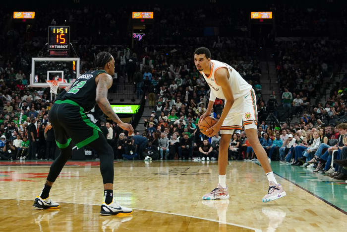 Dec 31, 2023; San Antonio, Texas, USA; San Antonio Spurs center Victor Wembanyama (1) faces off against Boston Celtics forward Oshae Brissett (12) in the second half at Frost Bank Center.